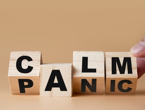 Hand flipping wooden cubes for change wording" Panic "  to " Calm".  Mindset is important for human development.