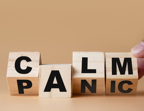 Hand flipping wooden cubes for change wording" Panic "  to " Calm".  Mindset is important for human development.